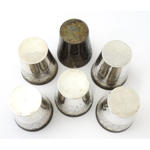 277 - A set of six white metal tot cups with engraved decoration and Persian style script. Approx 1 1/2