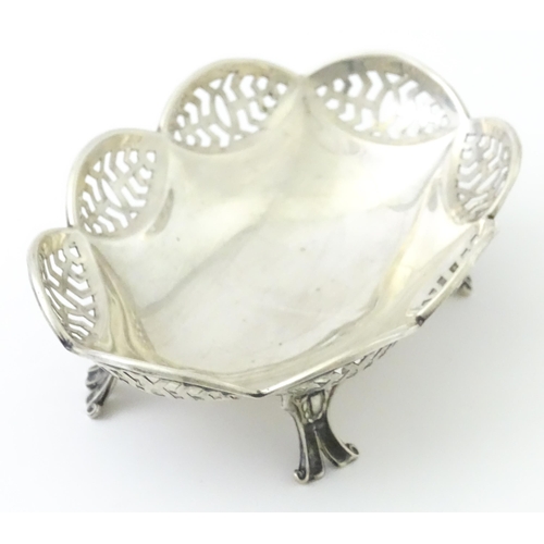 279 - A silver bonbon dish with pierced decoration and raised on four feet, hallmarked Birmingham 1913 mak... 