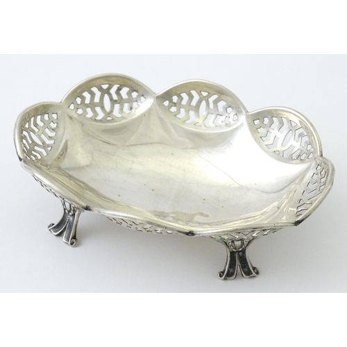 279 - A silver bonbon dish with pierced decoration and raised on four feet, hallmarked Birmingham 1913 mak... 