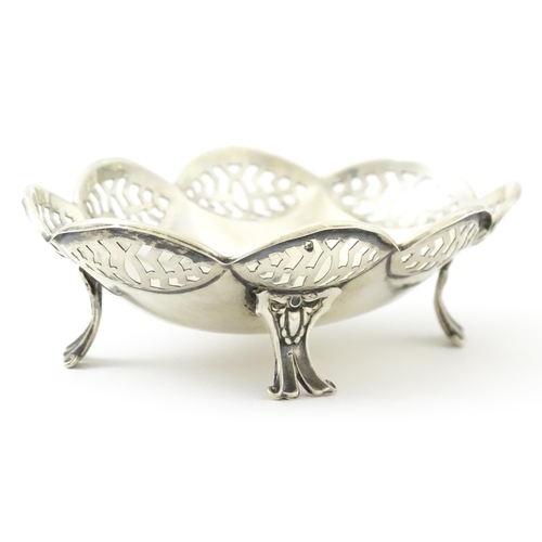279 - A silver bonbon dish with pierced decoration and raised on four feet, hallmarked Birmingham 1913 mak... 