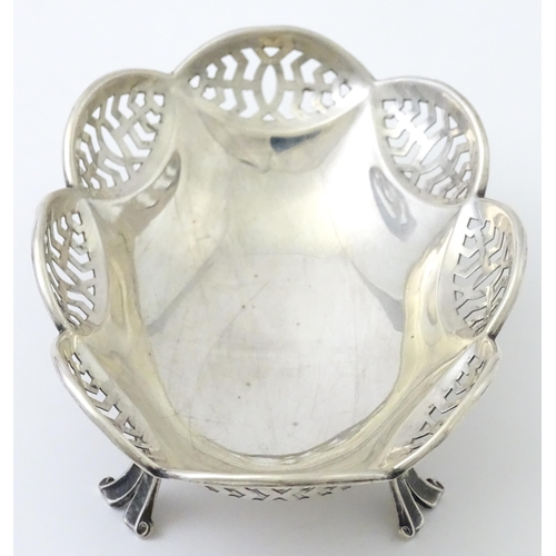 279 - A silver bonbon dish with pierced decoration and raised on four feet, hallmarked Birmingham 1913 mak... 