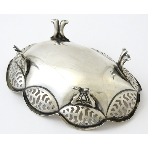 279 - A silver bonbon dish with pierced decoration and raised on four feet, hallmarked Birmingham 1913 mak... 