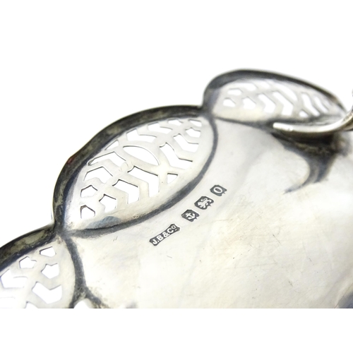 279 - A silver bonbon dish with pierced decoration and raised on four feet, hallmarked Birmingham 1913 mak... 