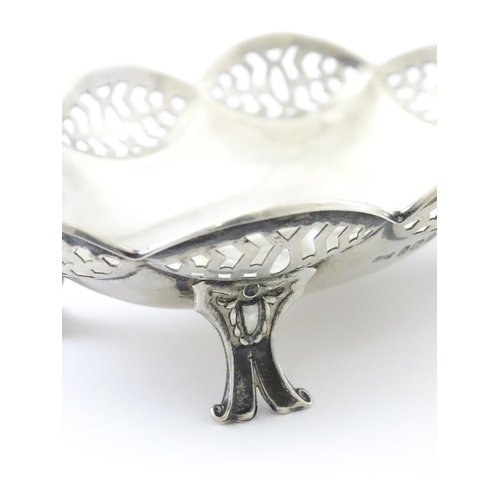 279 - A silver bonbon dish with pierced decoration and raised on four feet, hallmarked Birmingham 1913 mak... 