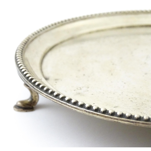 292 - A silver card tray raised on three feet. Hallmarked London 1908 maker John Henry Rawlings. Approx 7 ... 