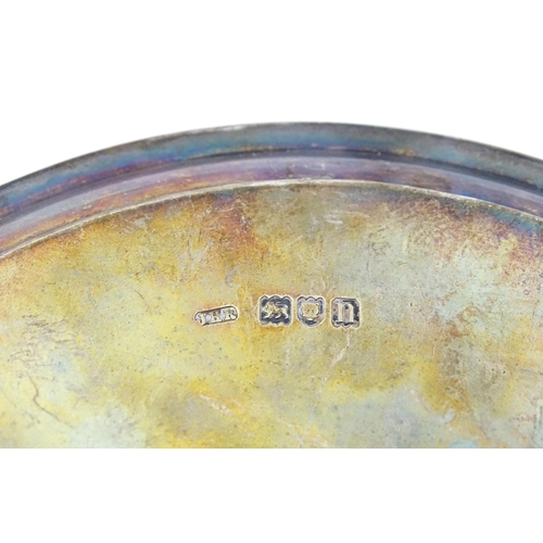 292 - A silver card tray raised on three feet. Hallmarked London 1908 maker John Henry Rawlings. Approx 7 ... 