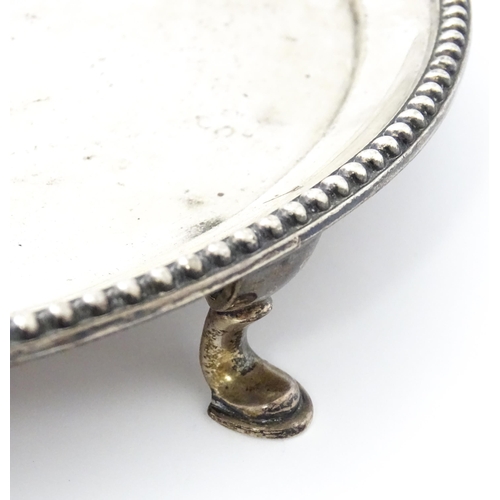 292 - A silver card tray raised on three feet. Hallmarked London 1908 maker John Henry Rawlings. Approx 7 ... 