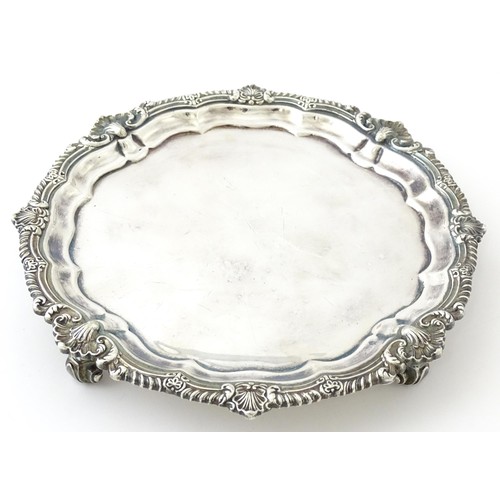 398 - A silver plate salver /card tray raised on four scrolling feet, marked Harrods. Approx. 8 3/4