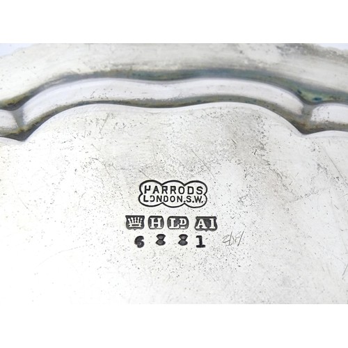 398 - A silver plate salver /card tray raised on four scrolling feet, marked Harrods. Approx. 8 3/4