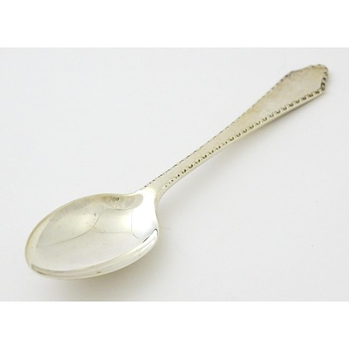 403 - A silver bud vase, hallmarked Birmingham 1988, maker A. E. Jones. Together with a silver teaspoon, h... 