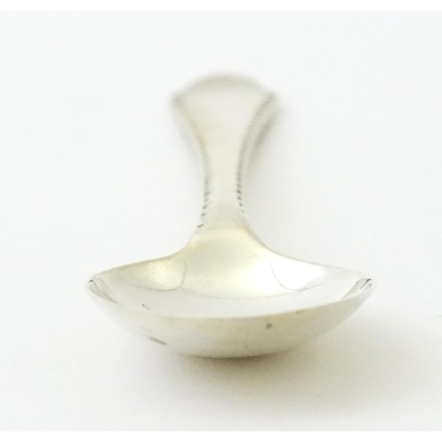 403 - A silver bud vase, hallmarked Birmingham 1988, maker A. E. Jones. Together with a silver teaspoon, h... 