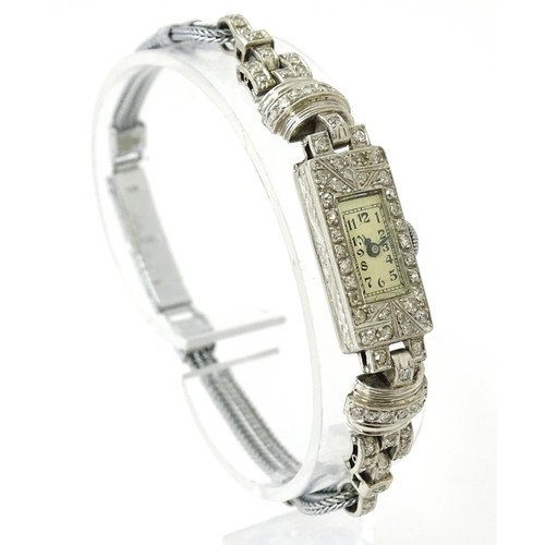 769 - A ladies Art Deco Seeland Watch Co. platinum cased wristwatch set with diamonds. The watch approx 1/... 