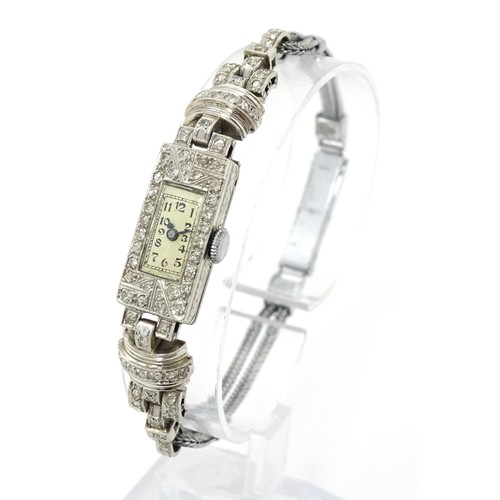 769 - A ladies Art Deco Seeland Watch Co. platinum cased wristwatch set with diamonds. The watch approx 1/... 