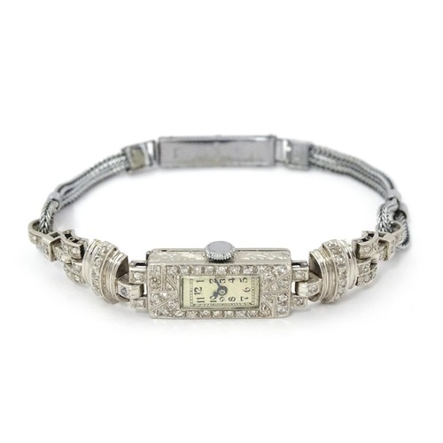 769 - A ladies Art Deco Seeland Watch Co. platinum cased wristwatch set with diamonds. The watch approx 1/... 
