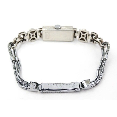 769 - A ladies Art Deco Seeland Watch Co. platinum cased wristwatch set with diamonds. The watch approx 1/... 