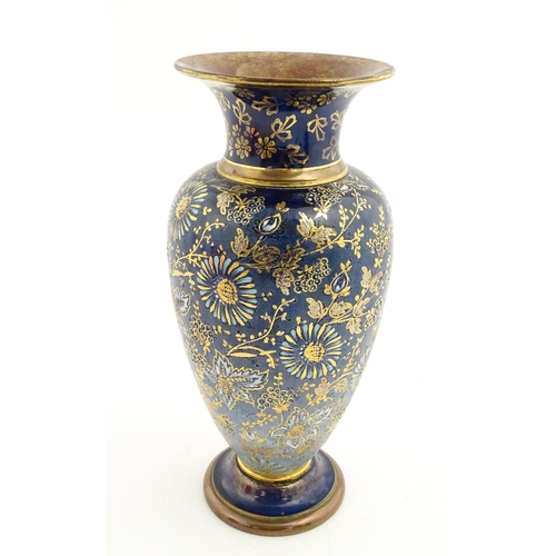 103 - A Doulton Lambeth vase decorated with flowers and foliage, having gilt highlights. Marked under with... 