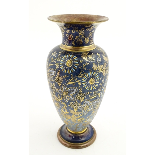 103 - A Doulton Lambeth vase decorated with flowers and foliage, having gilt highlights. Marked under with... 