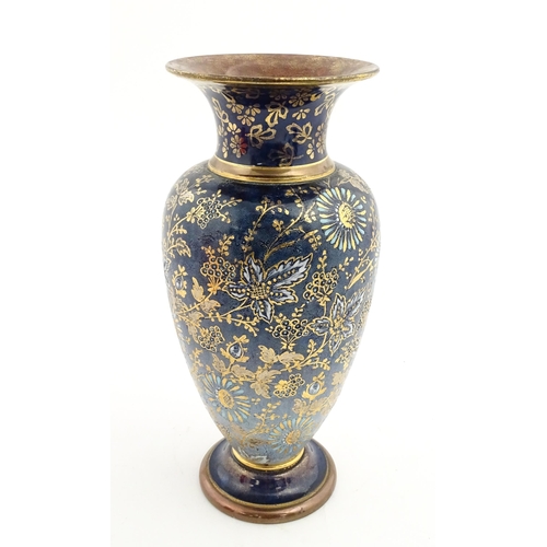103 - A Doulton Lambeth vase decorated with flowers and foliage, having gilt highlights. Marked under with... 