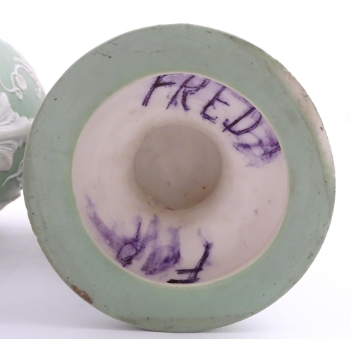 110 - A pair of parian vases in the manner of Wedgwood Jasperware depicting the Three Graces to one side, ... 