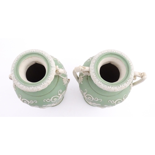 110 - A pair of parian vases in the manner of Wedgwood Jasperware depicting the Three Graces to one side, ... 