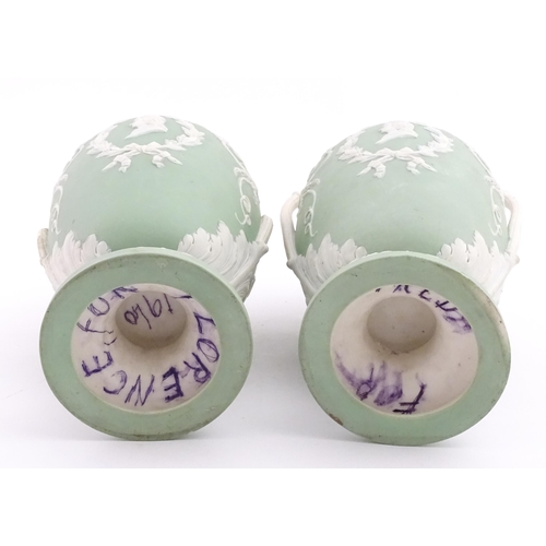 110 - A pair of parian vases in the manner of Wedgwood Jasperware depicting the Three Graces to one side, ... 