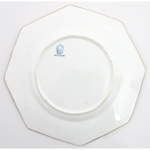 112 - Two Wedgwood plates of octagonal form with hand painted flower decoration. Marked under. Approx. 8 3... 