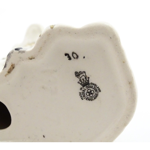 117 - A pair of small Royal Doulton Staffordshire style seated spaniels. Approx. 3 1/2