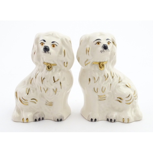 117 - A pair of small Royal Doulton Staffordshire style seated spaniels. Approx. 3 1/2