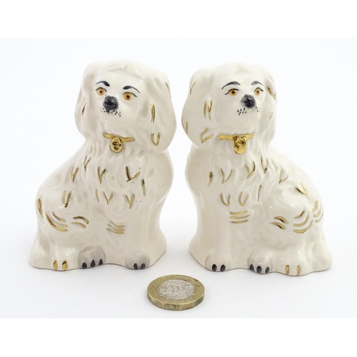 117 - A pair of small Royal Doulton Staffordshire style seated spaniels. Approx. 3 1/2
