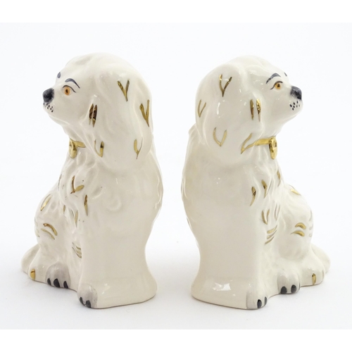 117 - A pair of small Royal Doulton Staffordshire style seated spaniels. Approx. 3 1/2