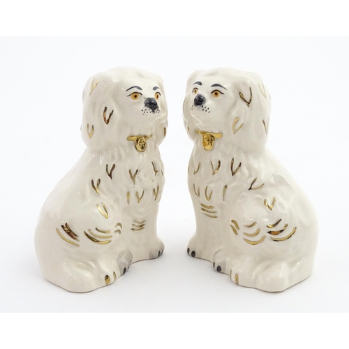 117 - A pair of small Royal Doulton Staffordshire style seated spaniels. Approx. 3 1/2