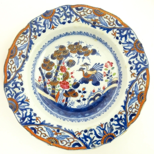 66 - A pair of Japanese vases decorated in the Imari palette decorated with flowers and foliage. Together... 