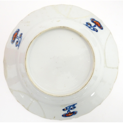 66 - A pair of Japanese vases decorated in the Imari palette decorated with flowers and foliage. Together... 