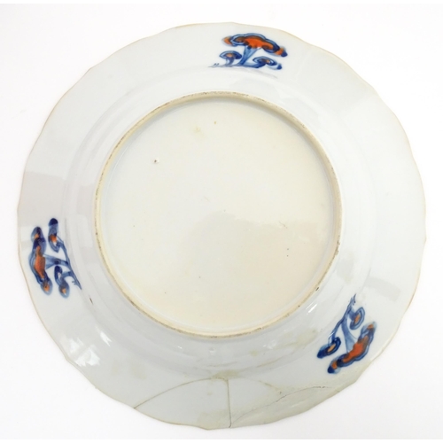 66 - A pair of Japanese vases decorated in the Imari palette decorated with flowers and foliage. Together... 