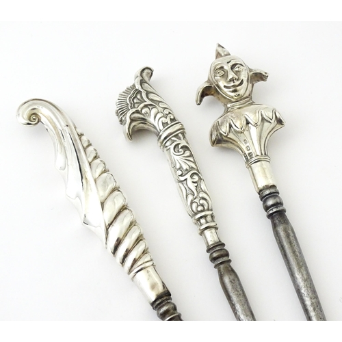 361 - Three various silver and white metal handled button hooks including one with floral and scroll detai... 