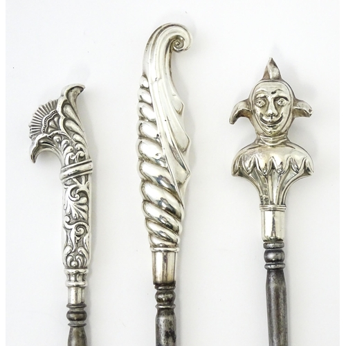 361 - Three various silver and white metal handled button hooks including one with floral and scroll detai... 