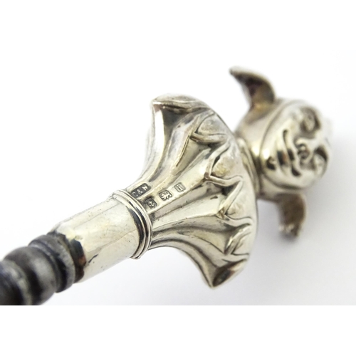 361 - Three various silver and white metal handled button hooks including one with floral and scroll detai... 