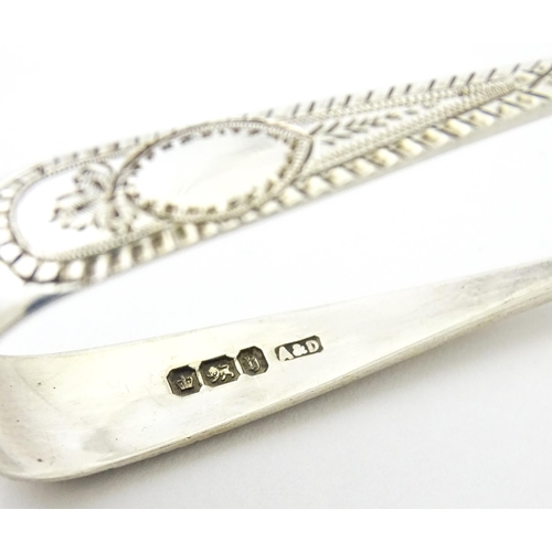 409 - Five assorted silver flatware to include a pair of teaspoons hallmarked London 1910, sugar tongs hal... 