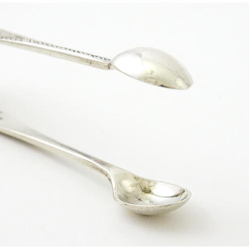 409 - Five assorted silver flatware to include a pair of teaspoons hallmarked London 1910, sugar tongs hal... 
