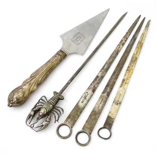 412 - Assorted items to include three silver plate meat skewers, a skewer surmounted by a model of a lobst... 