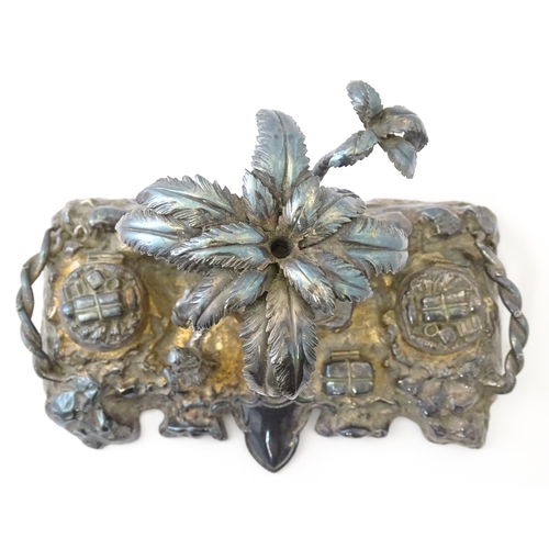 371 - A Victorian silver plate inkstand modelled as a man riding a camel with an attendant below two palm ... 