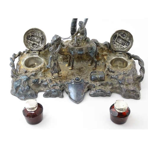 371 - A Victorian silver plate inkstand modelled as a man riding a camel with an attendant below two palm ... 