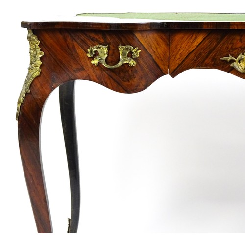 1428 - A 19thC rosewood bureau plat / writing desk with a shaped top above single short drawer and gilt mou... 