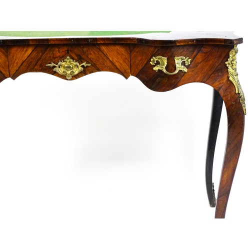 1428 - A 19thC rosewood bureau plat / writing desk with a shaped top above single short drawer and gilt mou... 