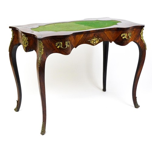 1428 - A 19thC rosewood bureau plat / writing desk with a shaped top above single short drawer and gilt mou... 