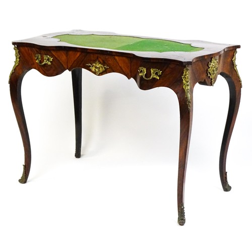 1428 - A 19thC rosewood bureau plat / writing desk with a shaped top above single short drawer and gilt mou... 