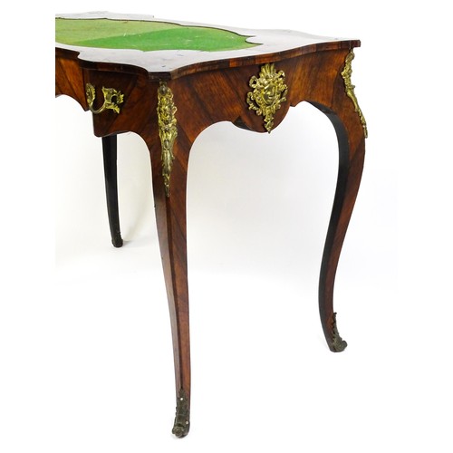 1428 - A 19thC rosewood bureau plat / writing desk with a shaped top above single short drawer and gilt mou... 