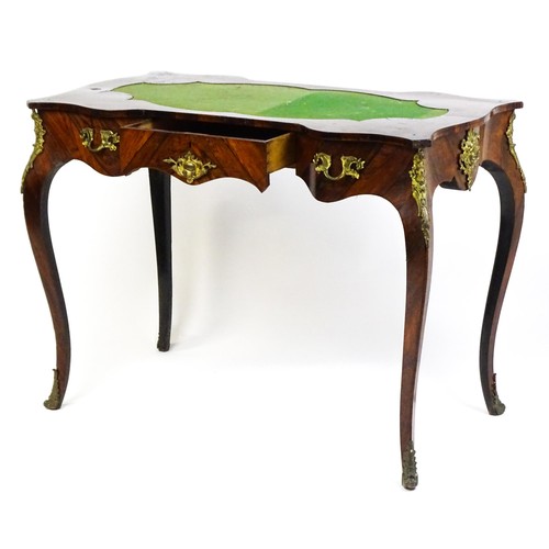 1428 - A 19thC rosewood bureau plat / writing desk with a shaped top above single short drawer and gilt mou... 