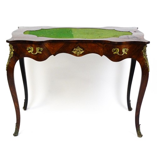 1428 - A 19thC rosewood bureau plat / writing desk with a shaped top above single short drawer and gilt mou... 