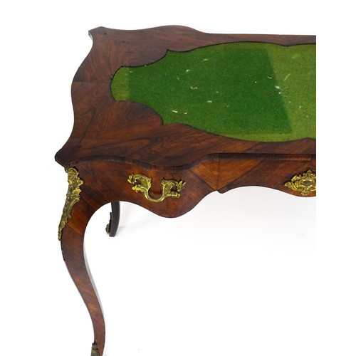 1428 - A 19thC rosewood bureau plat / writing desk with a shaped top above single short drawer and gilt mou... 